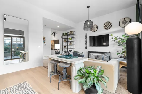 a view of a dining room kitchen with furniture and chandelier