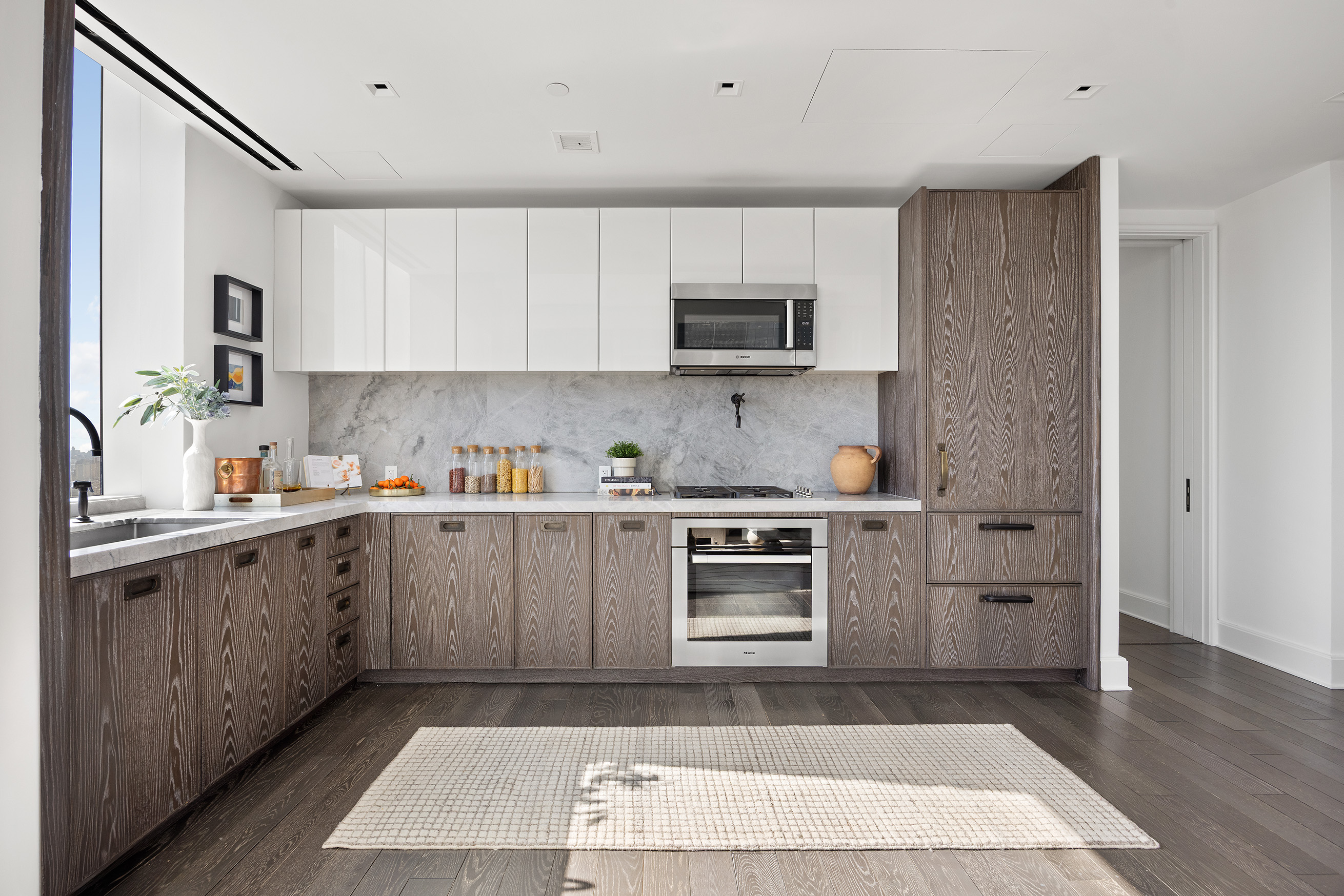 45 East 22nd Street, Unit 32B Manhattan, NY 10010 - Photo 14 of 36 a kitchen with stainless steel appliances granite countertop a refrigerator and a stove top oven