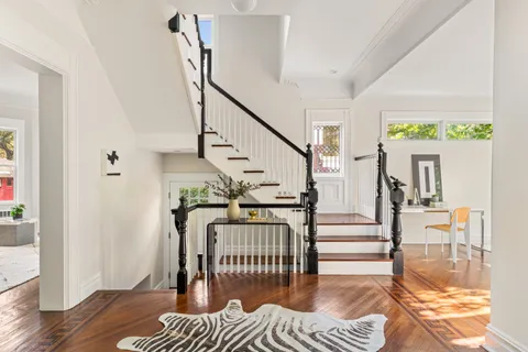 a view of entryway dining room and hall with wooden floor