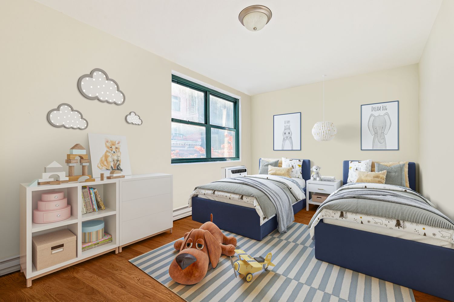 a bedroom with two beds and a window