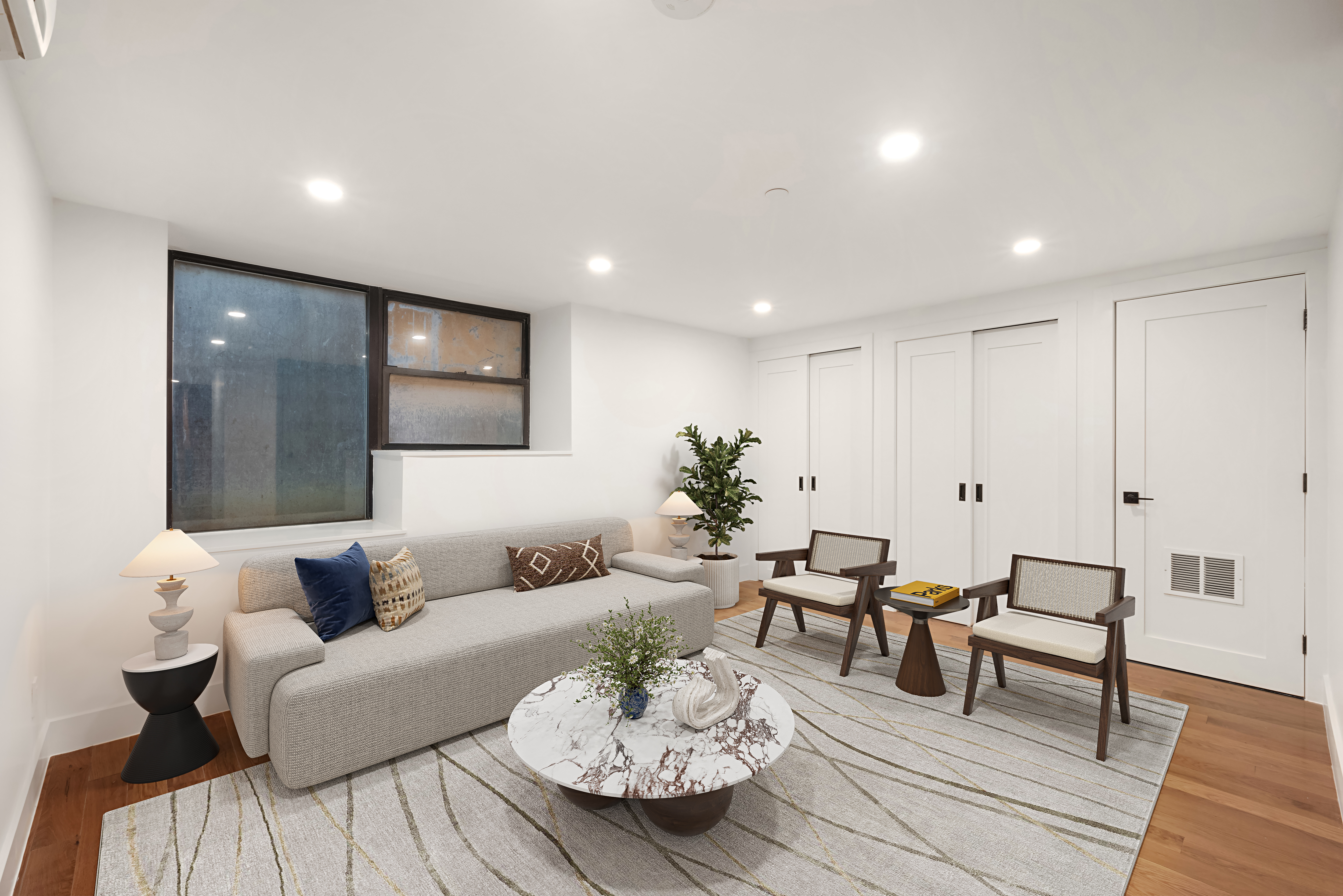 61 West 70th Street, Unit 1A Manhattan, NY 10023 - Photo 8 of 15 a living room with furniture and wooden floor