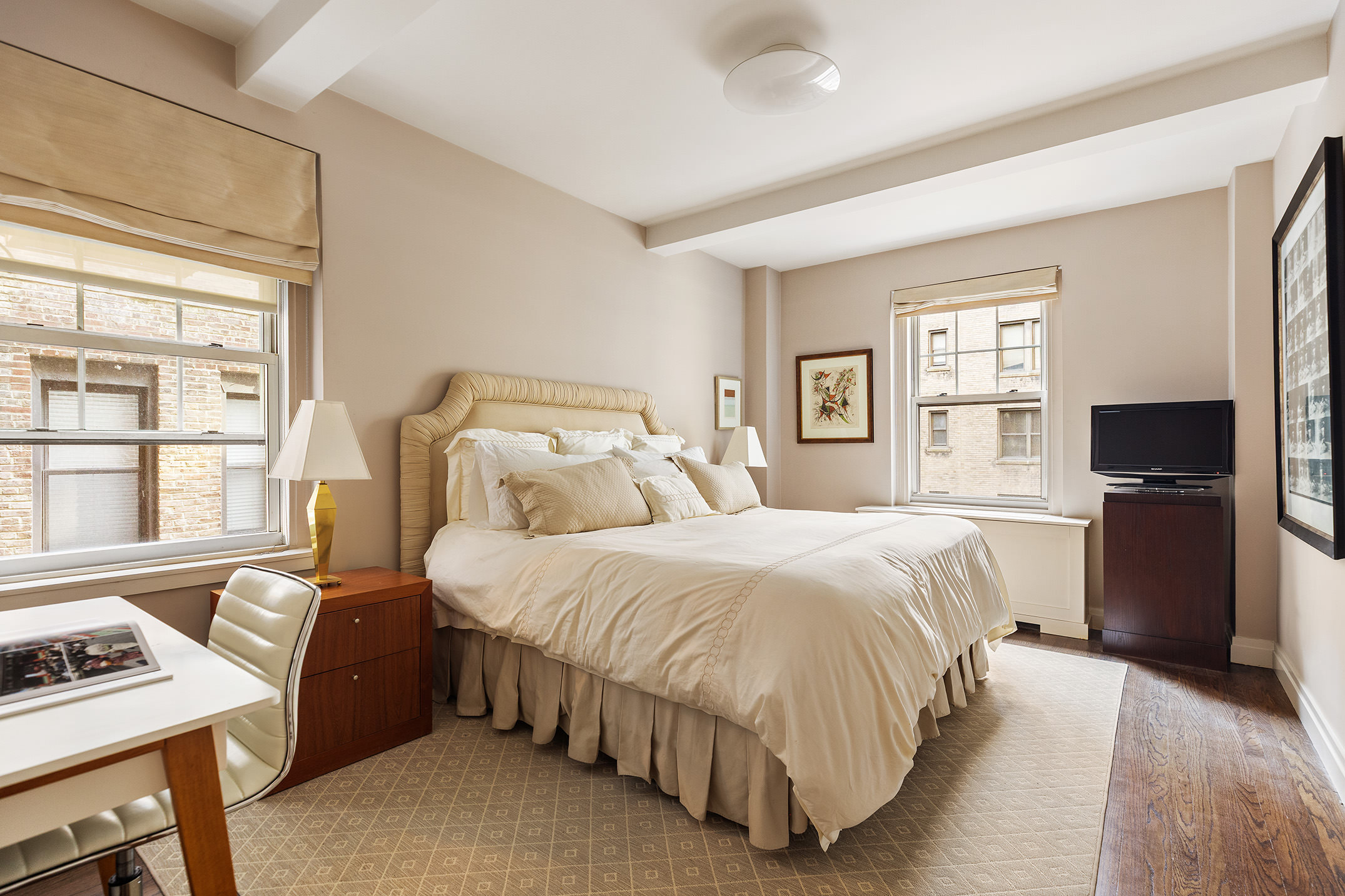 450 West End Avenue, Unit 3B Manhattan, NY 10024 - Photo 9 of 13 a bedroom with a bed and a flat screen tv