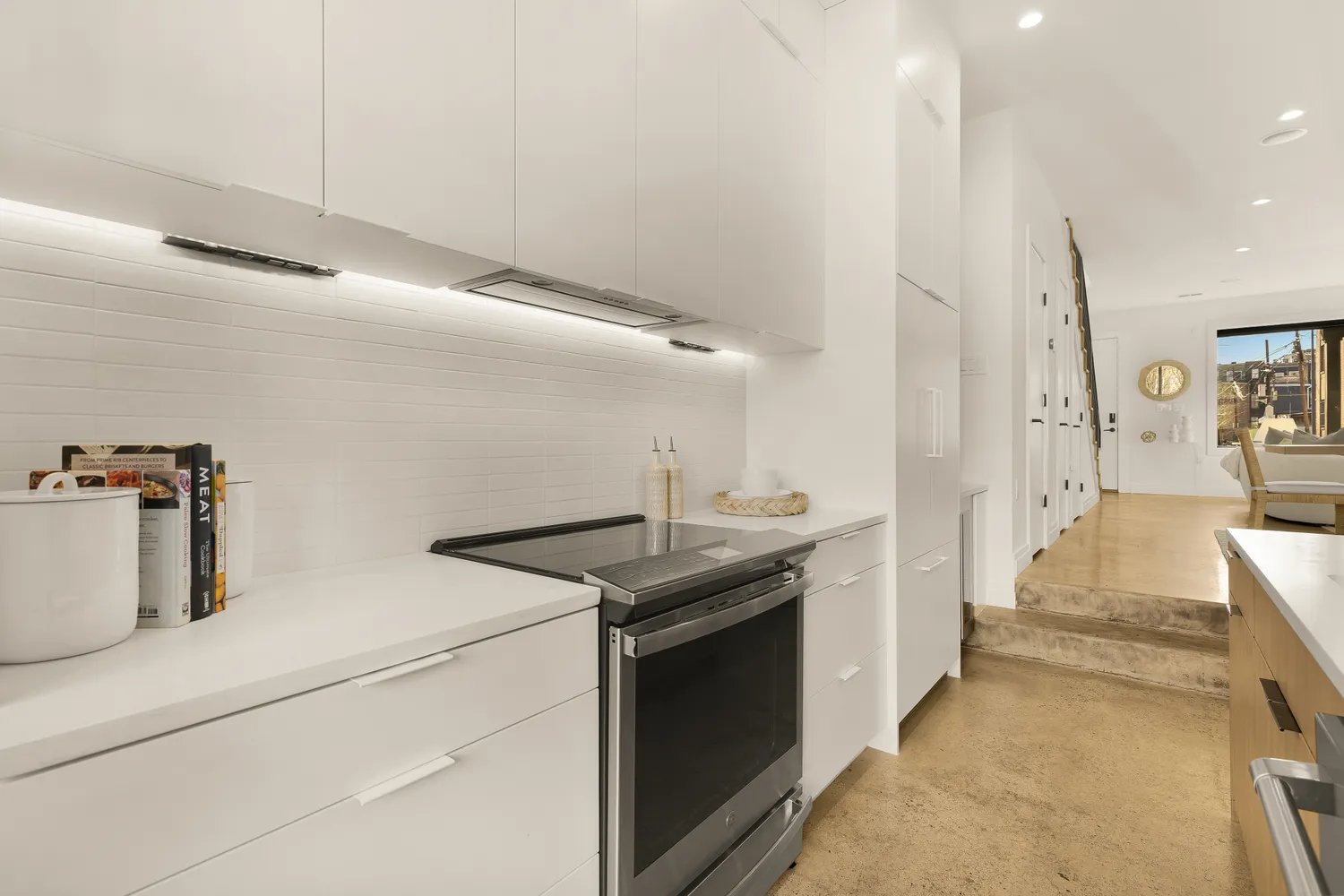 a kitchen with a sink a stove and cabinets