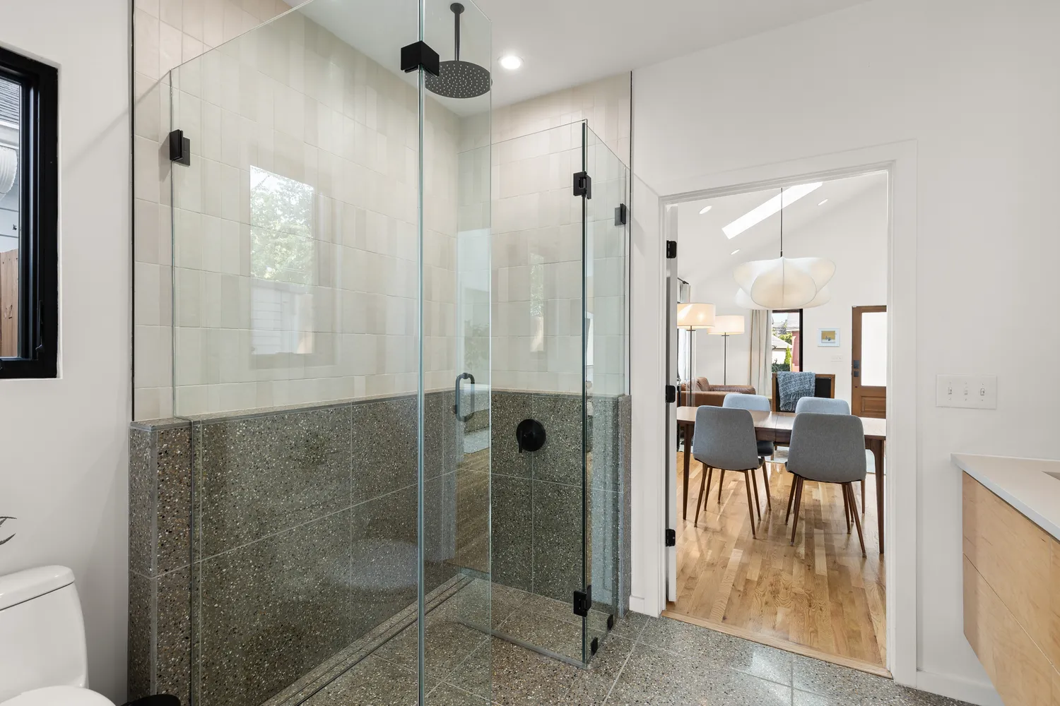 a bathroom with a glass shower door and a mirror