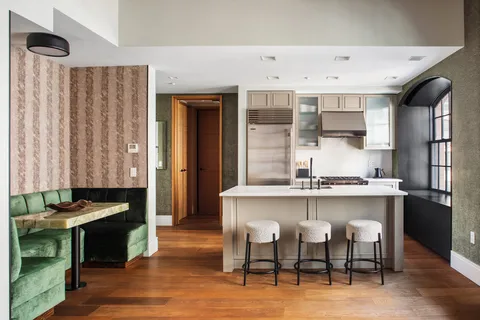 a kitchen with stainless steel appliances granite countertop a stove and a refrigerator