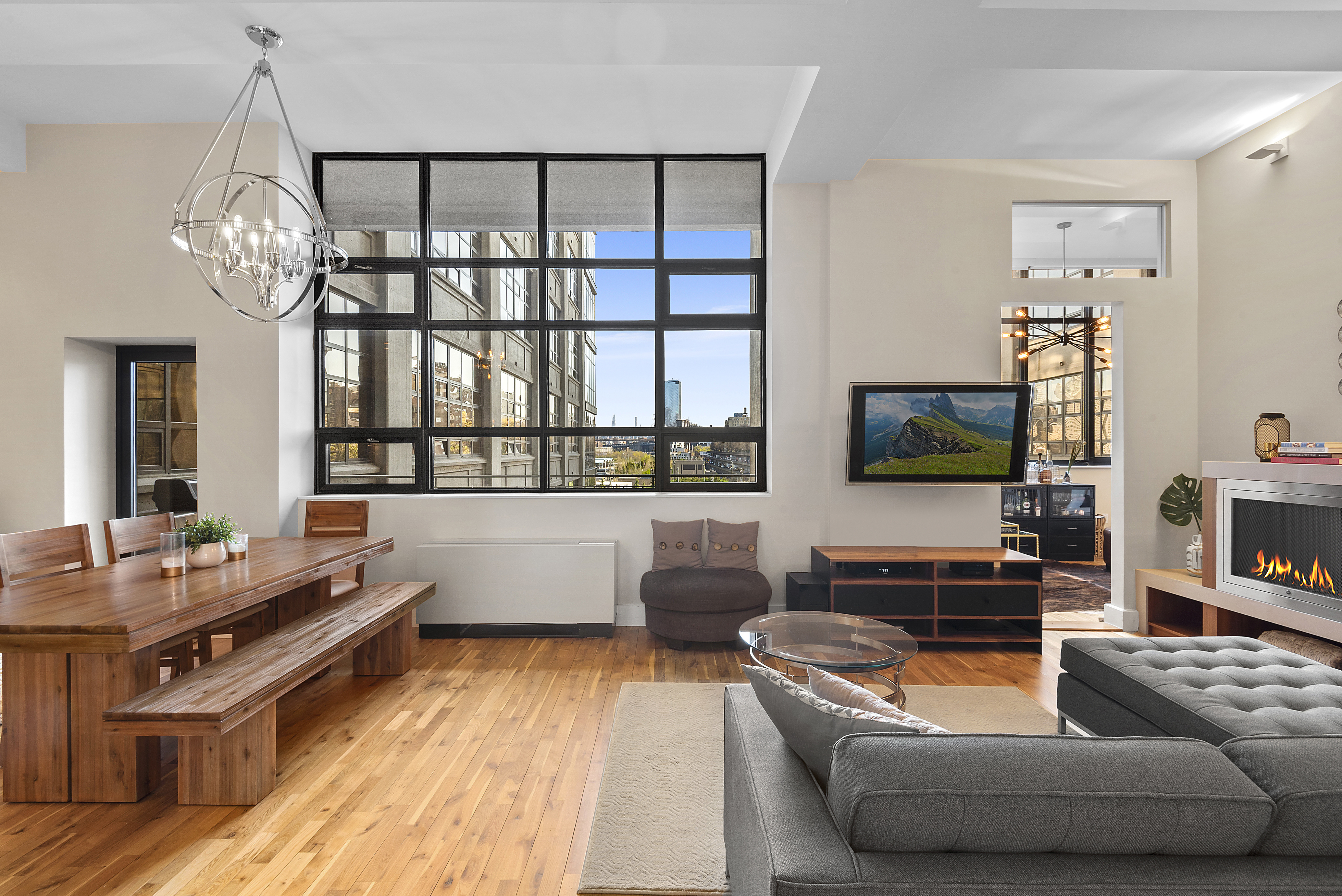 360 Furman Street, Unit 723/724 Brooklyn, NY 11201 - Photo 14 of 63 a living room with furniture and a flat screen tv