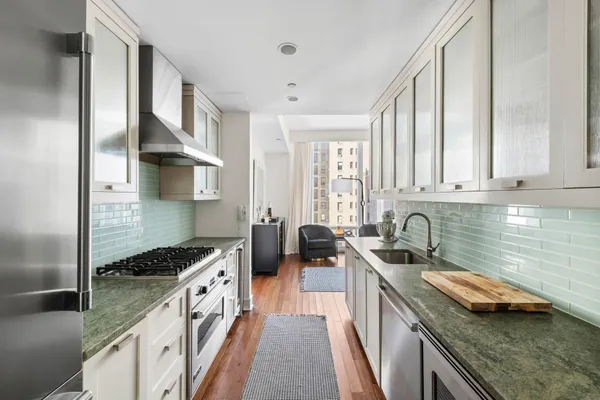 a kitchen with a sink stove top oven and cabinets