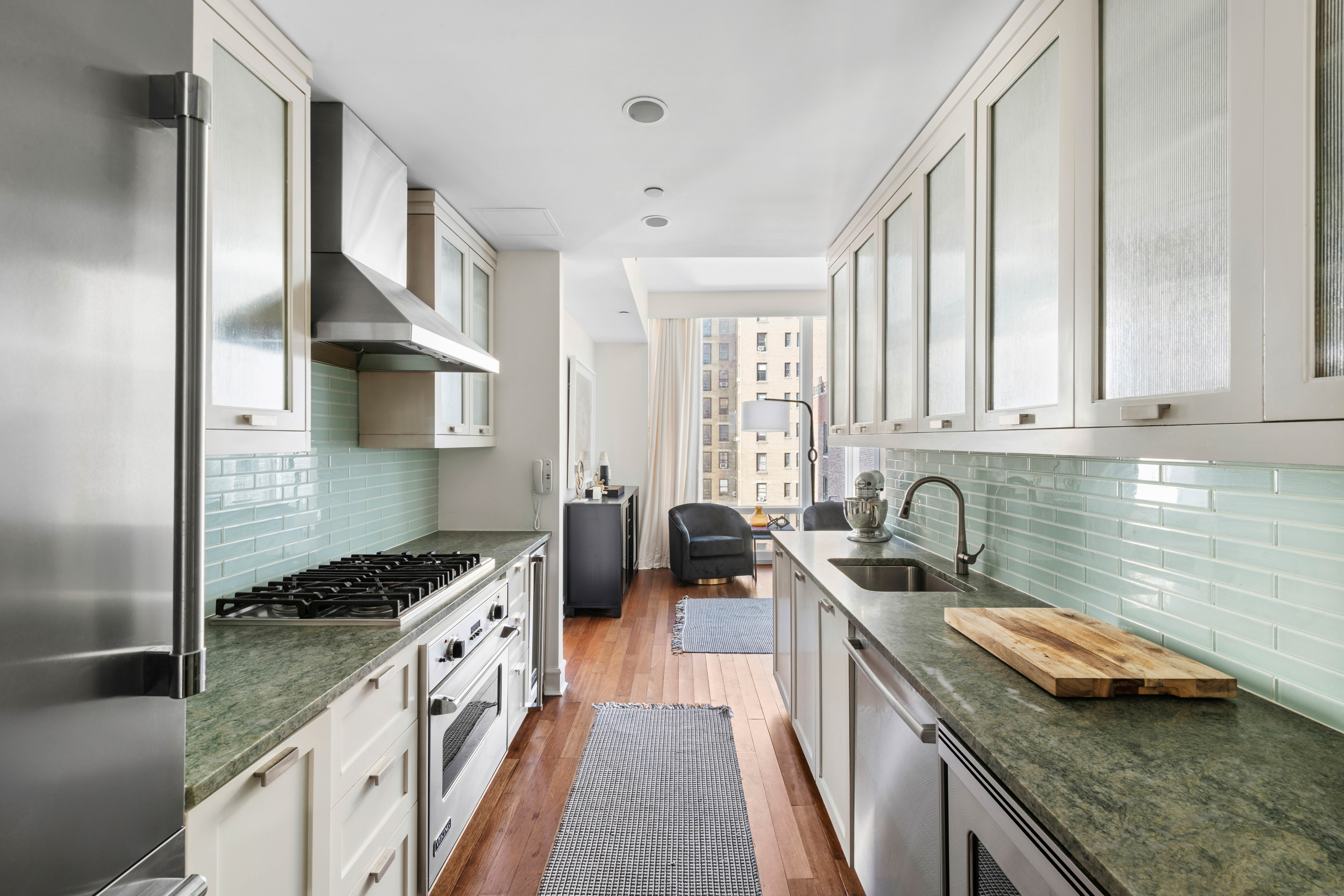 245 West 99th Street, Unit 8A Manhattan, NY 10025 - Photo 4 of 12 a kitchen with a sink stove top oven and cabinets