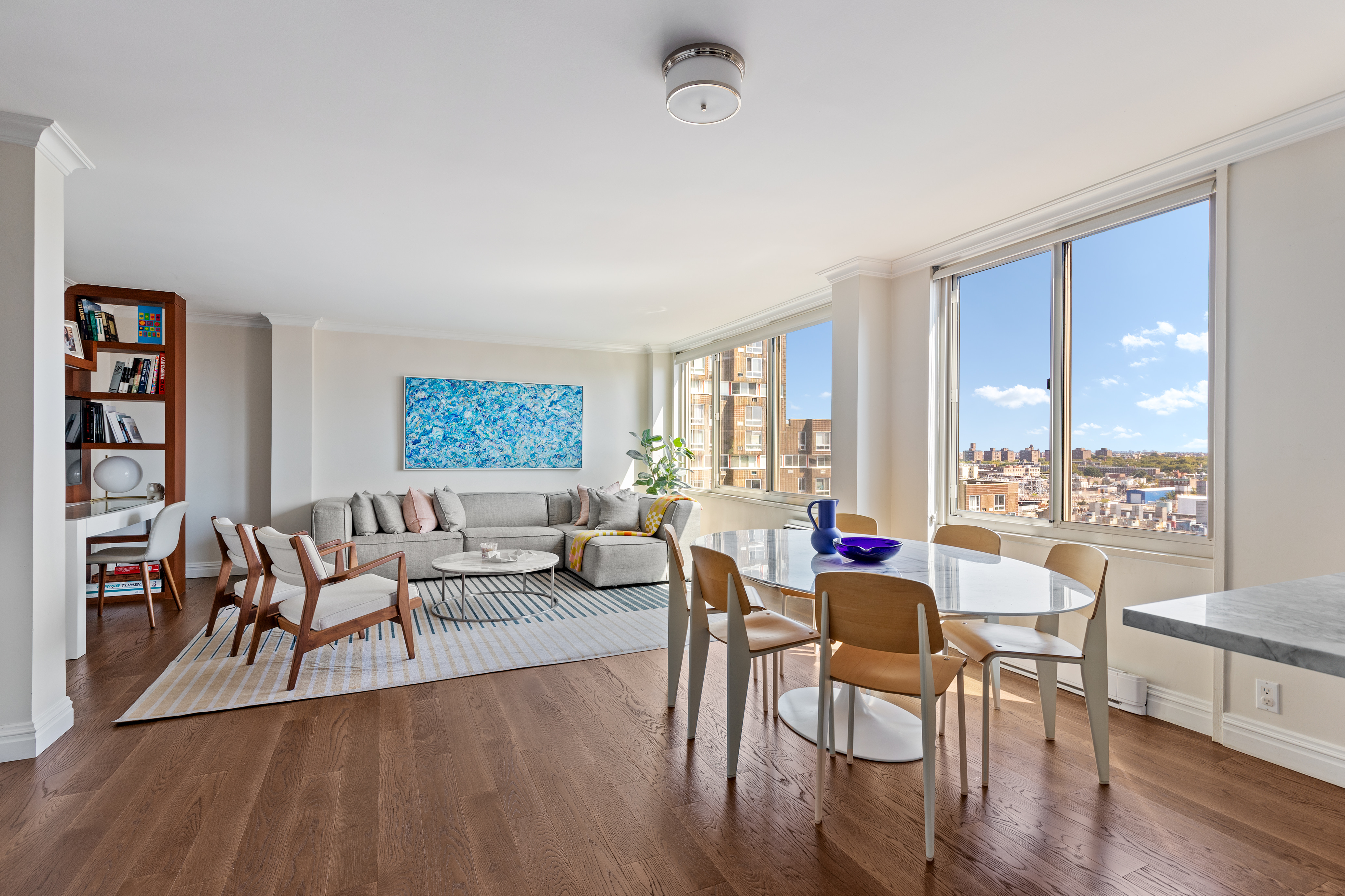 575 Main Street, Unit 1312 Manhattan, NY 10044 - Photo 9 of 25 a living room with furniture and a wooden floor