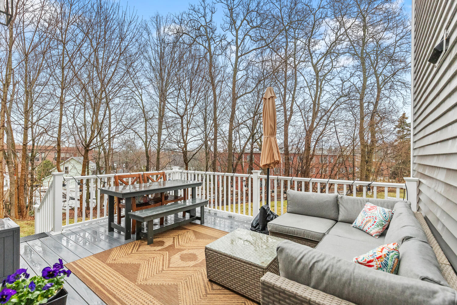 1 Maple Street, Unit 1 Maynard, MA 01754 - Photo 18 of 42 a roof deck with couches and wooden floor