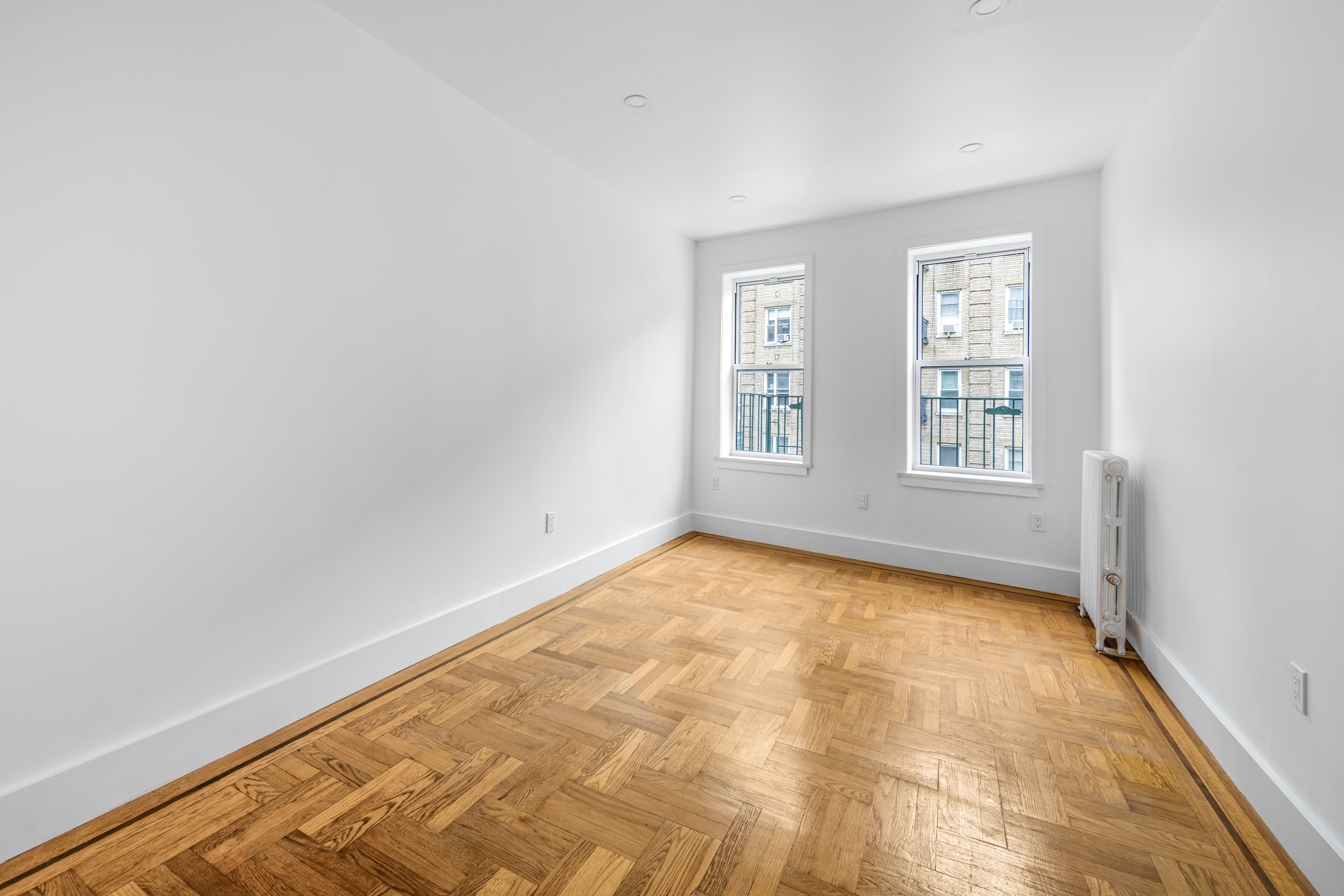 210 Grand Street, Unit 3F Manhattan, NY 10013 - Photo 6 of 11 an empty room with windows