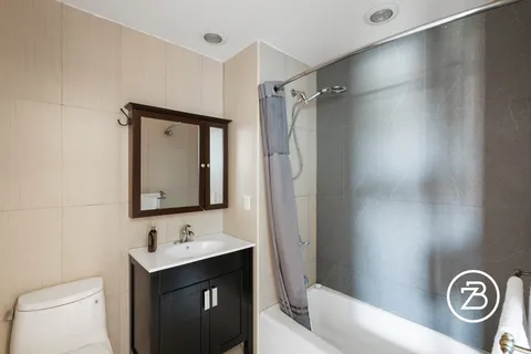 a bathroom with a bath tub sink and mirror