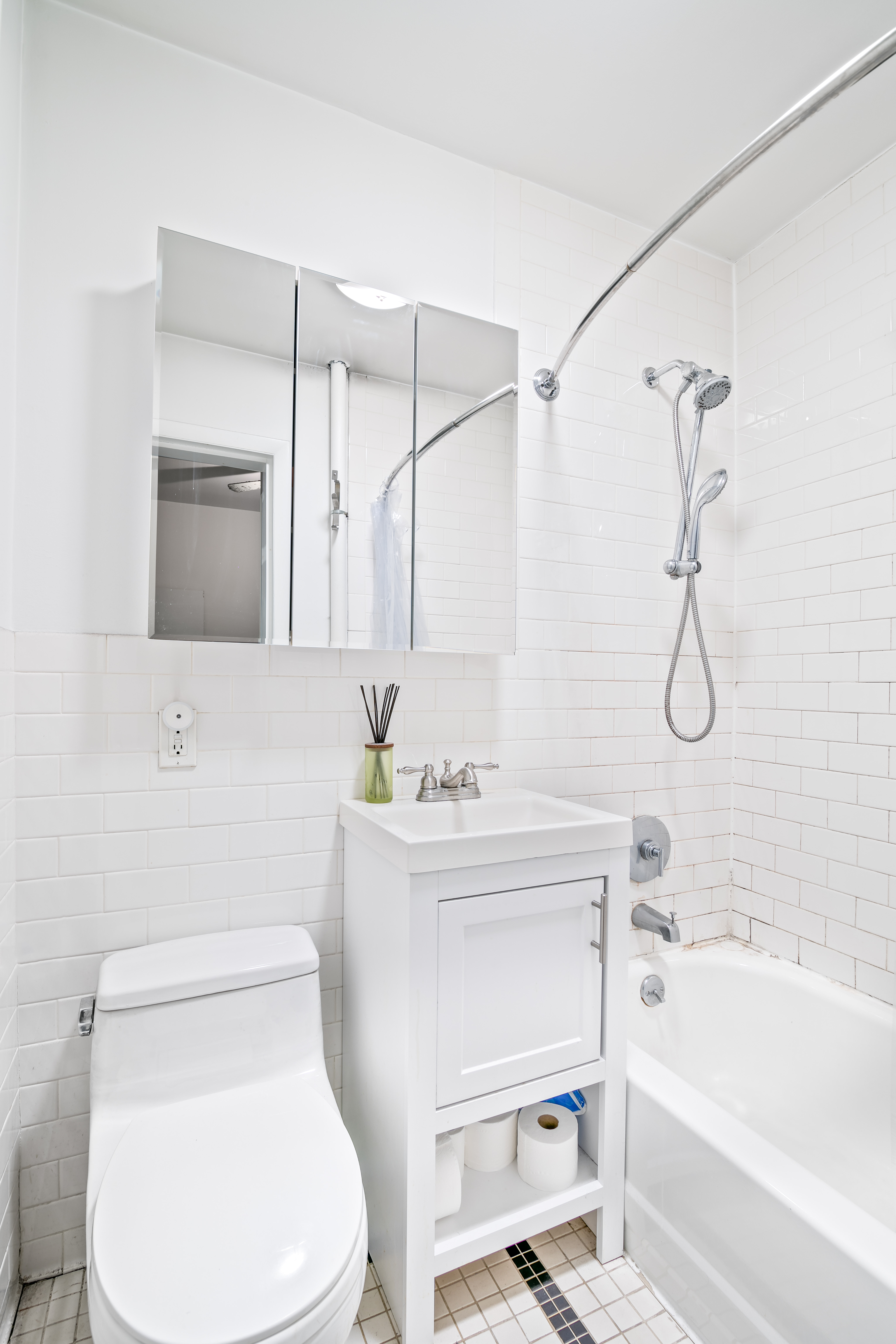 237 East 88th Street, Unit 401 Manhattan, NY 10128 - Photo 4 of 7 a bathroom with a sink a toilet and a bathtub