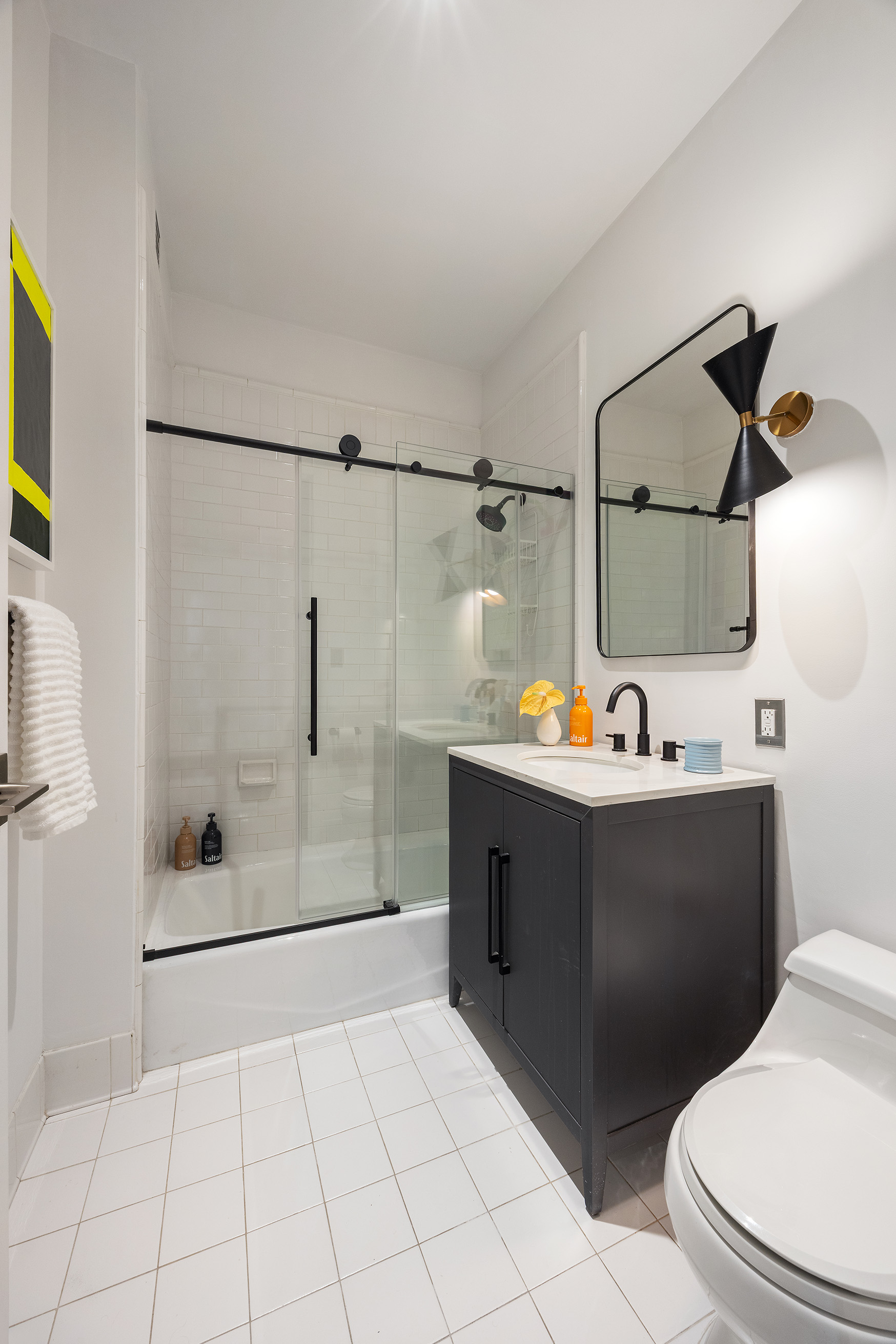 252 7th Avenue, Unit 9R Manhattan, NY 10001 - Photo 20 of 23 a bathroom with a sink a toilet and shower