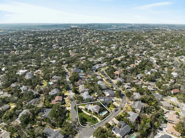 an aerial view of residential houses with city view