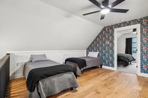 a bedroom with a bed and a chandelier