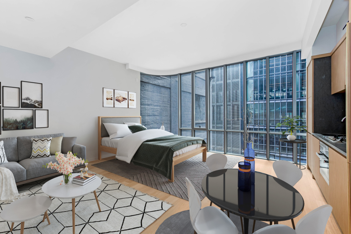 565 Broome Street, Unit N6I Manhattan, NY 10013 - Photo 2 of 15 a bedroom with furniture and a flat screen tv