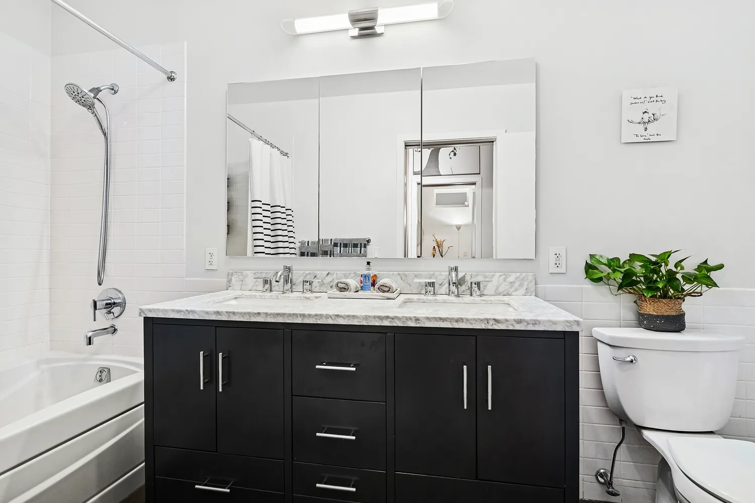 a bathroom with a granite countertop sink a toilet and shower