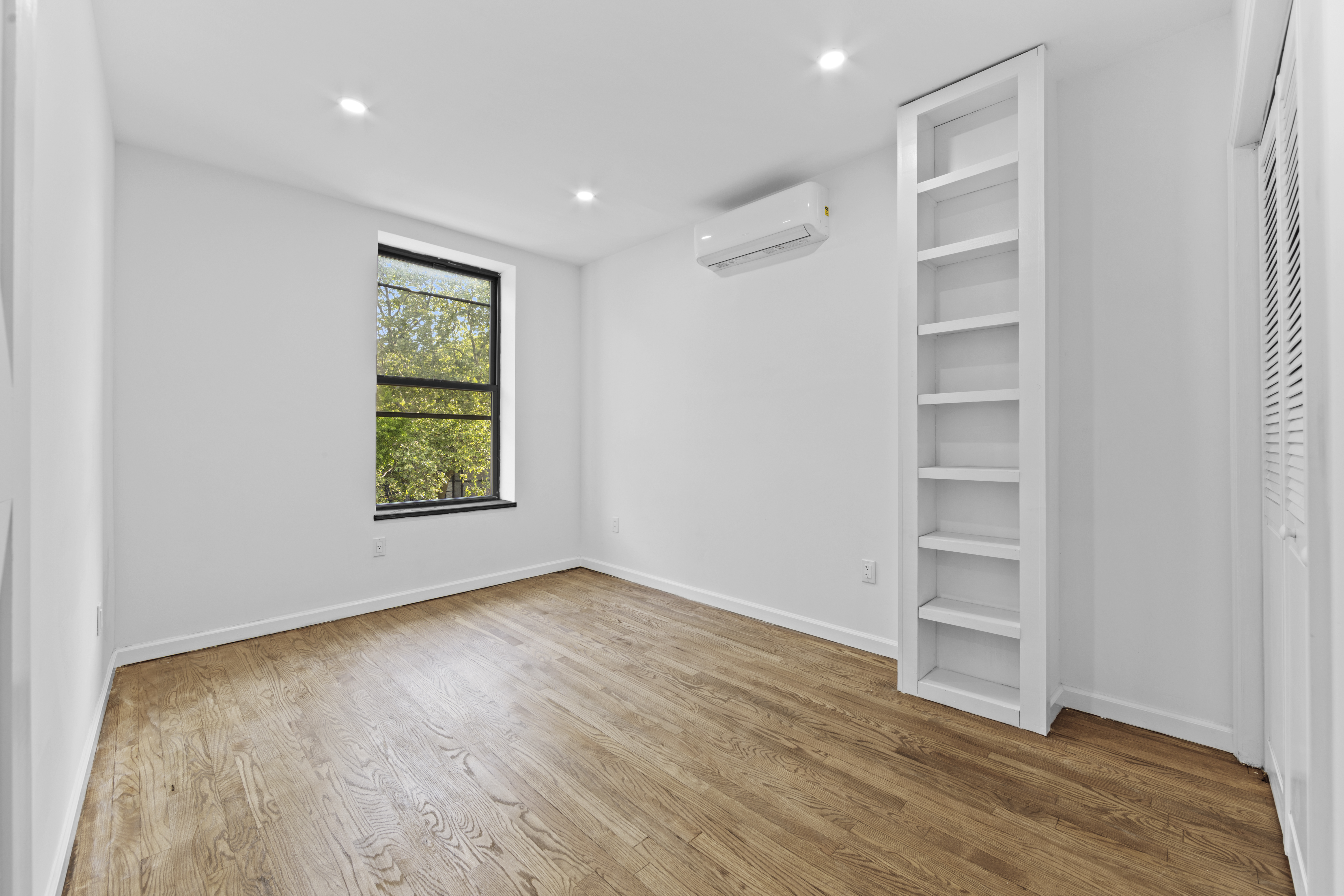 1061 Fulton Street, Unit 3 Brooklyn, NY 11238 - Photo 8 of 14 a view of an empty room with a window and wooden floor