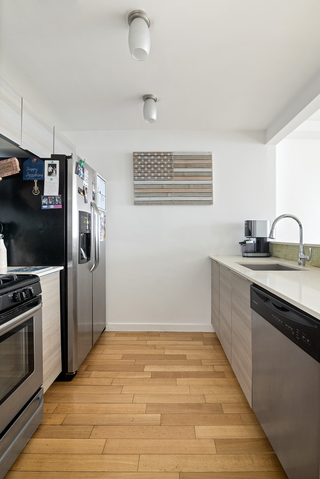 91-16 Shore Front Parkway, Unit 2F Queens, NY 11693 - Photo 4 of 9 a kitchen with stainless steel appliances granite countertop a sink stove and refrigerator