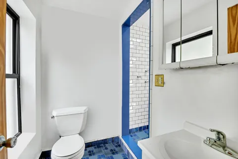 a picture of a bathroom with a shower