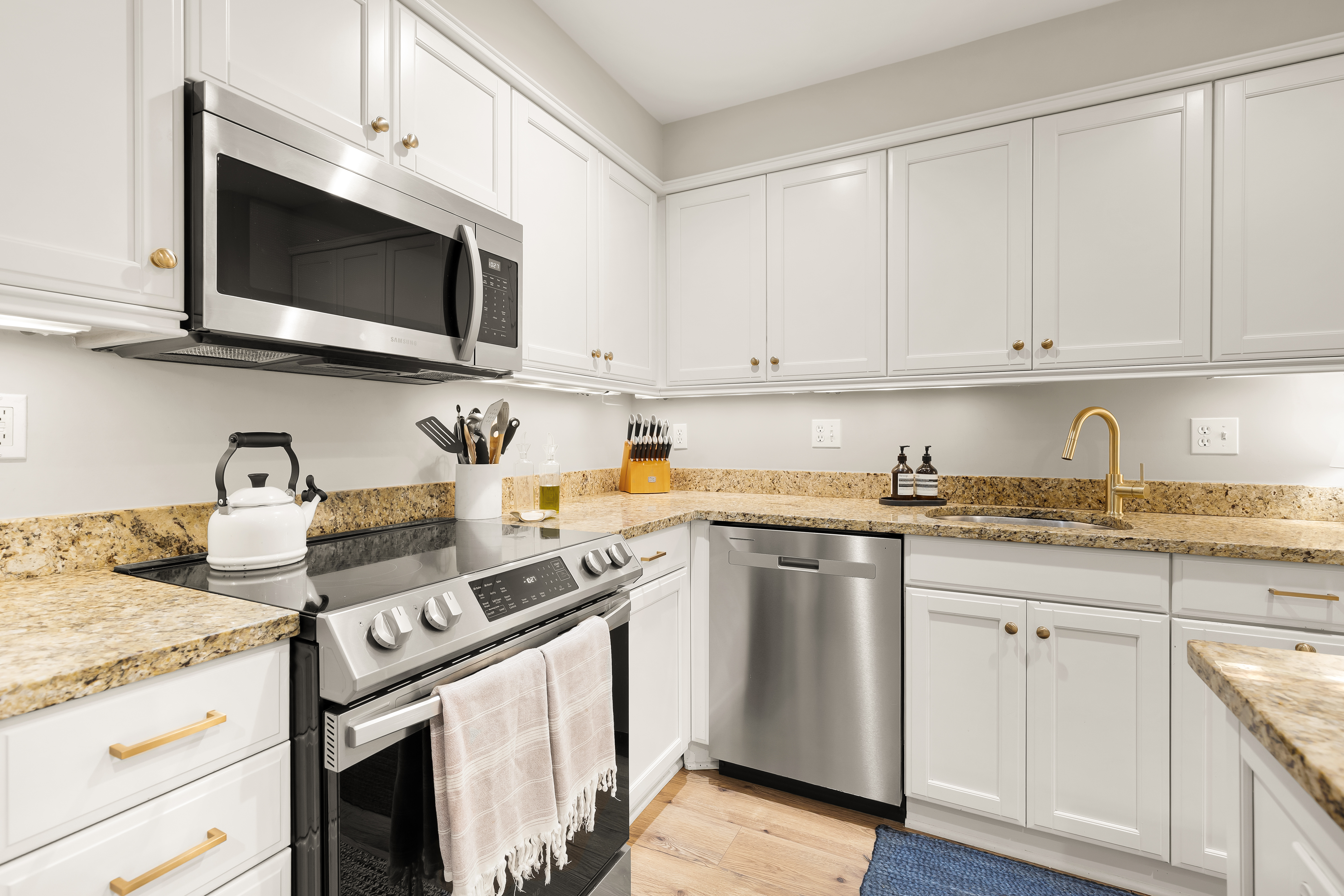1354 Kenyon Street Northwest, Unit G Washington, DC 20010 - Photo 17 of 35 a kitchen with stainless steel appliances granite countertop a sink and a stove