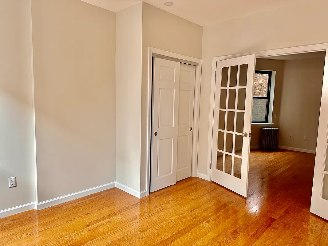 22 St Marks Place, Unit 16 Manhattan, NY 10003 - Photo 2 of 5 a view of empty room with wooden floor and fan