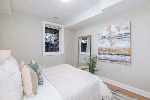 a bedroom with a bed and a painting on the wall