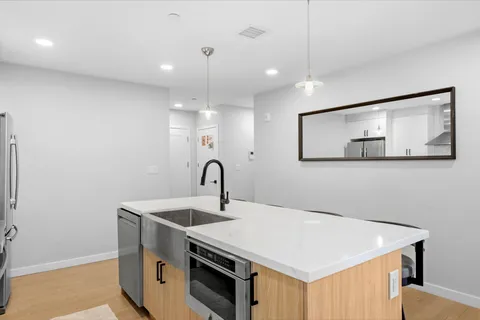 a kitchen that has a sink a stove and a microwave