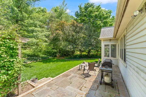 a view of a table and chairs in patio of the house