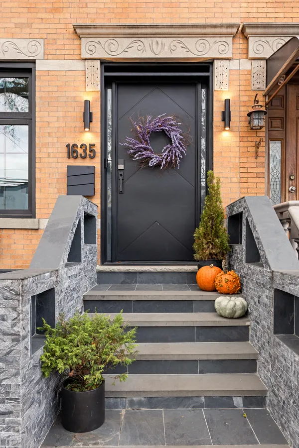 a front view of a house with outdoor seating