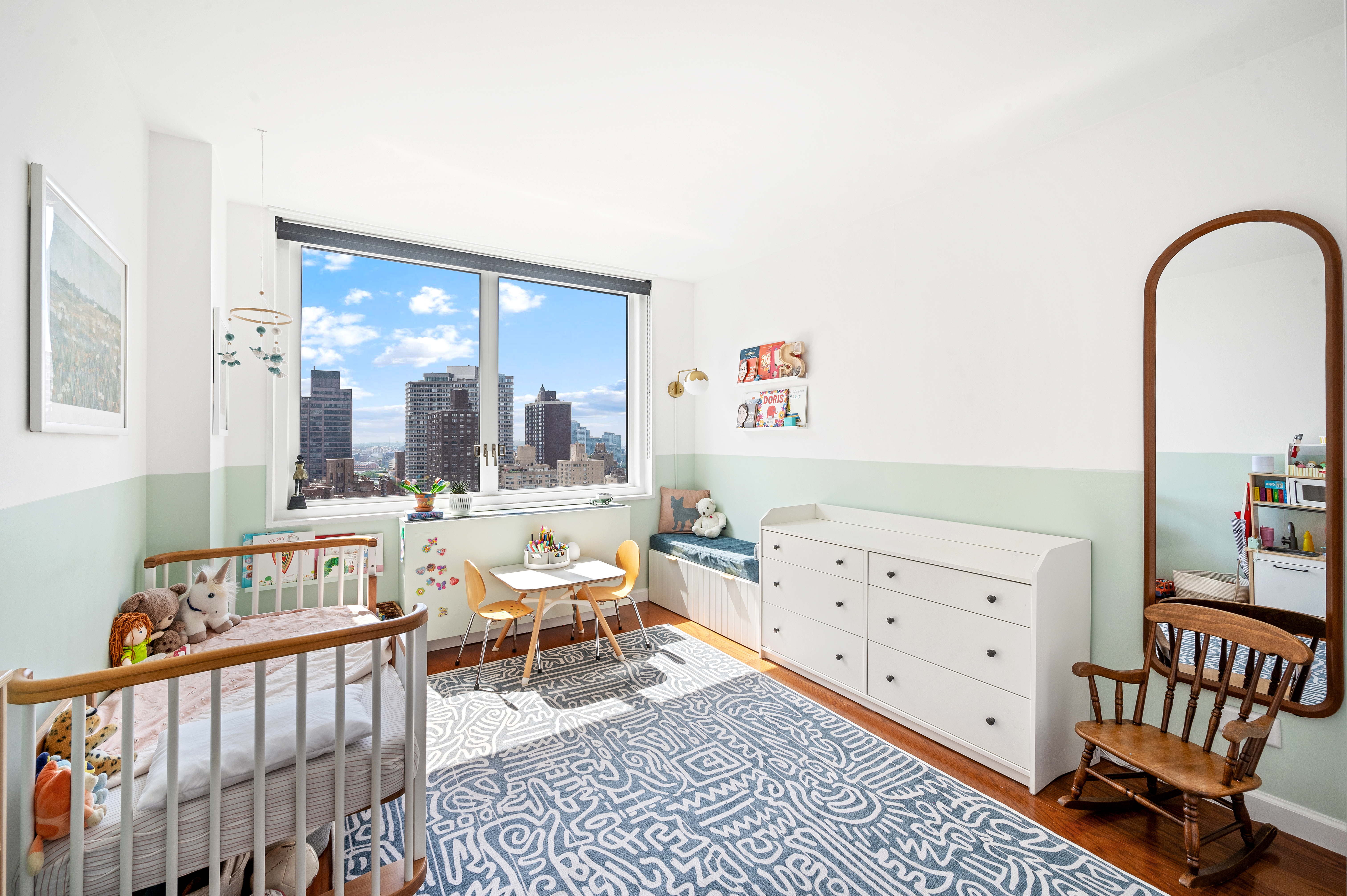 245 East 54th Street, Unit 26JK Manhattan, NY 10022 - Photo 11 of 12 a bedroom with furniture and a large window