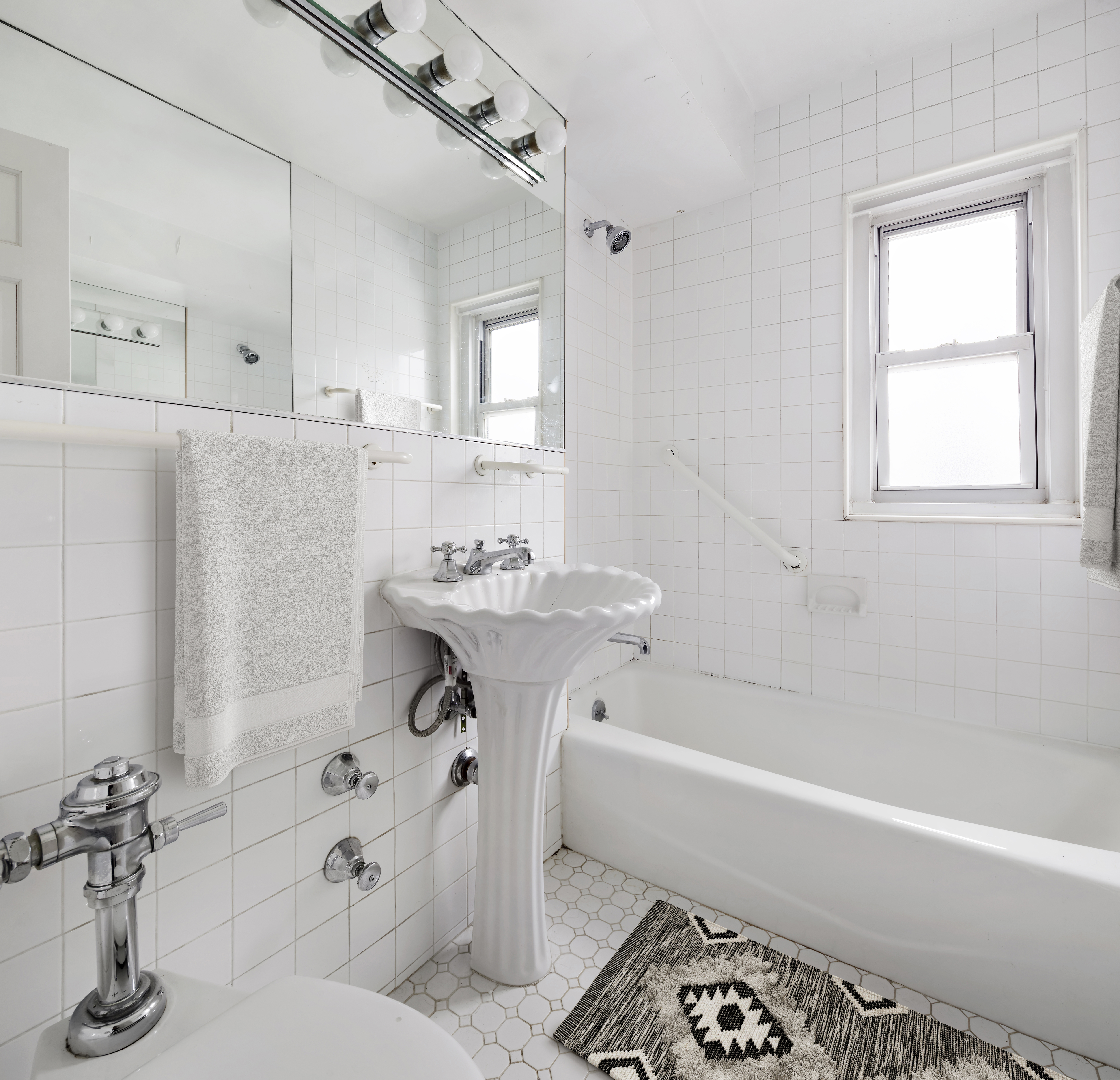 205 East 77th Street, Unit 10B Manhattan, NY 10075 - Photo 5 of 6 a bathroom with a sink and a bathtub