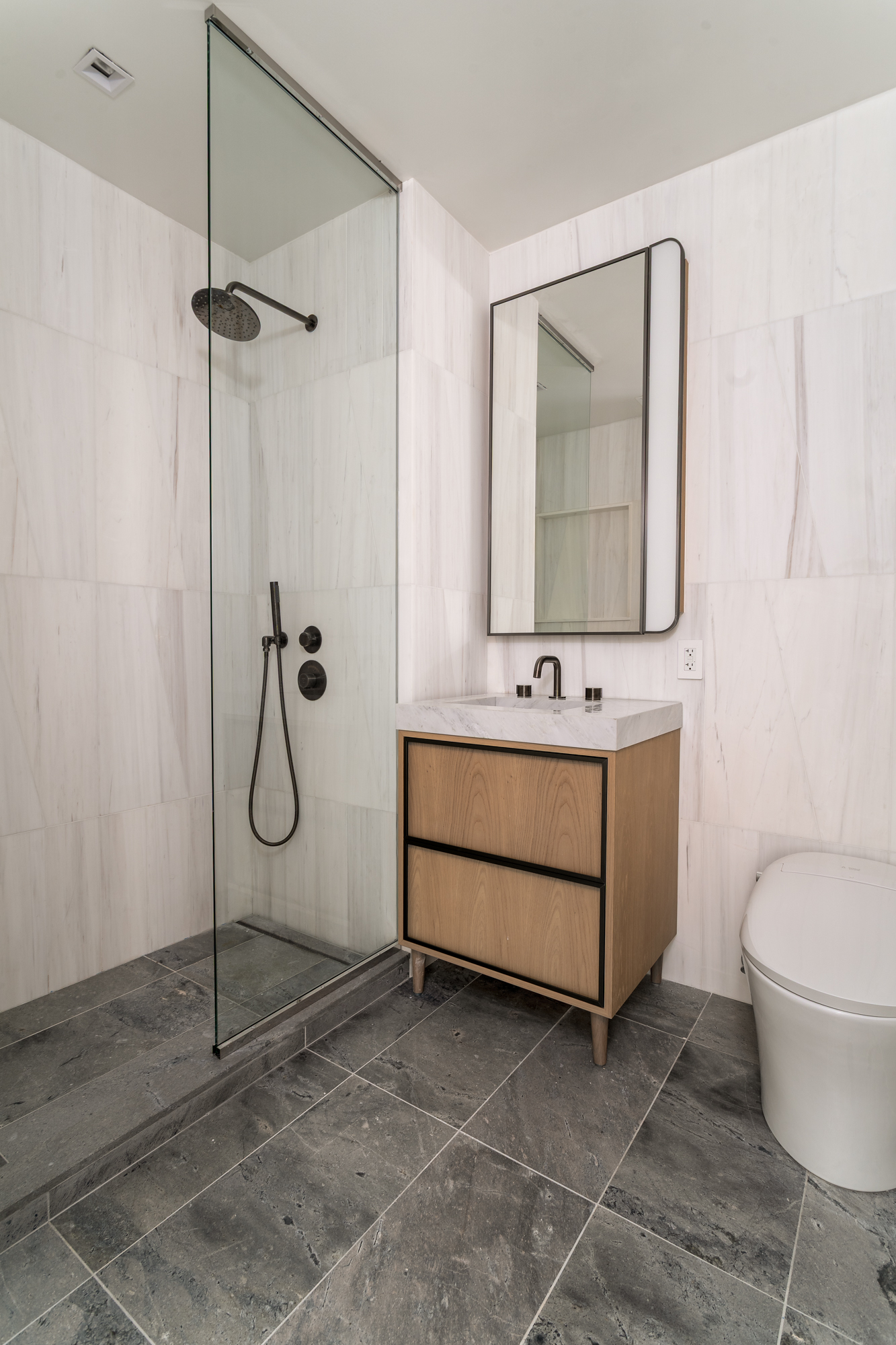 250 East 25th Street, Unit 4C Manhattan, NY 10010 - Photo 5 of 16 a bathroom with a toilet sink and mirror