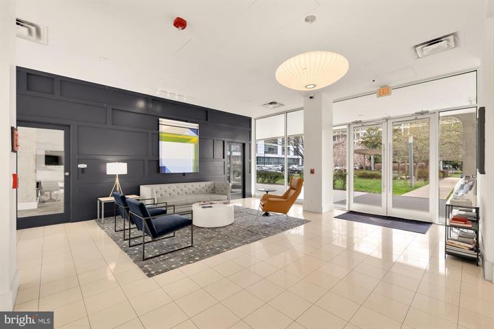 1101 3rd Street Southwest, Unit 206 Washington, DC 20024 - Photo 5 of 21 a living room with furniture and a large window