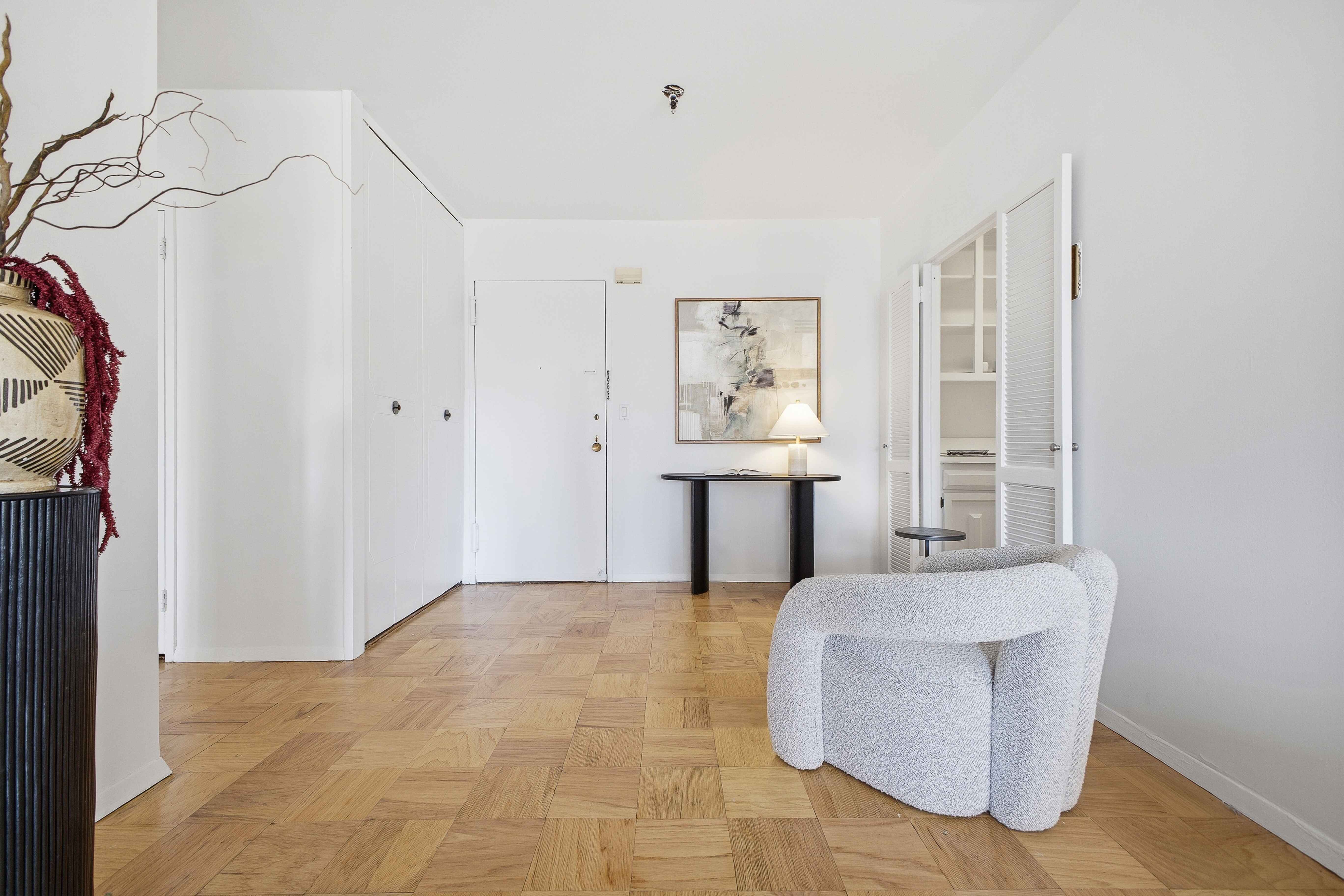 160 East 38th Street, Unit 26FG Manhattan, NY 10016 - Photo 6 of 23 a living room with furniture and a window