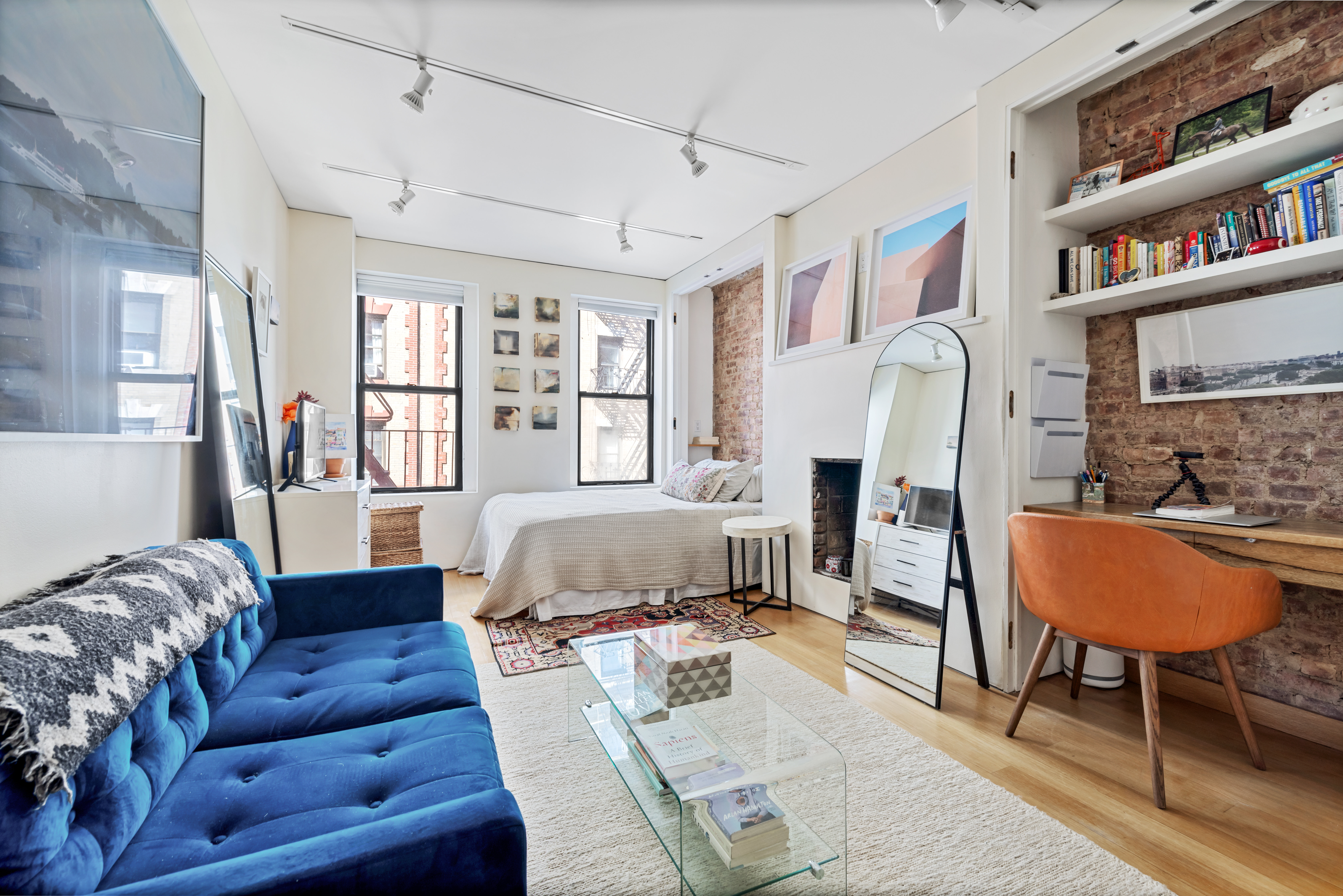 26 Cornelia Street, Unit 12 Manhattan, NY 10014 - Photo 1 of 7 a living room with furniture and a book shelf