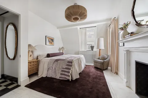 a bedroom with bed and a chandelier