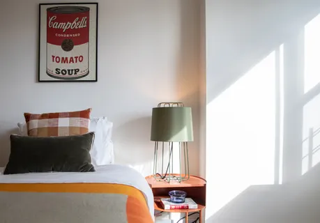 a living room with furniture and a lamp