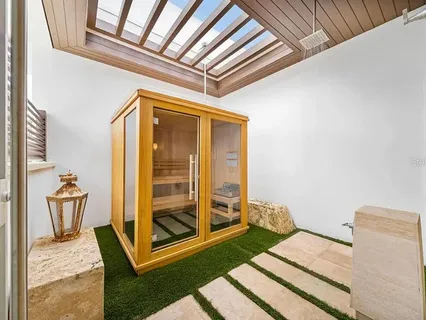 a bedroom with a bed and glass door