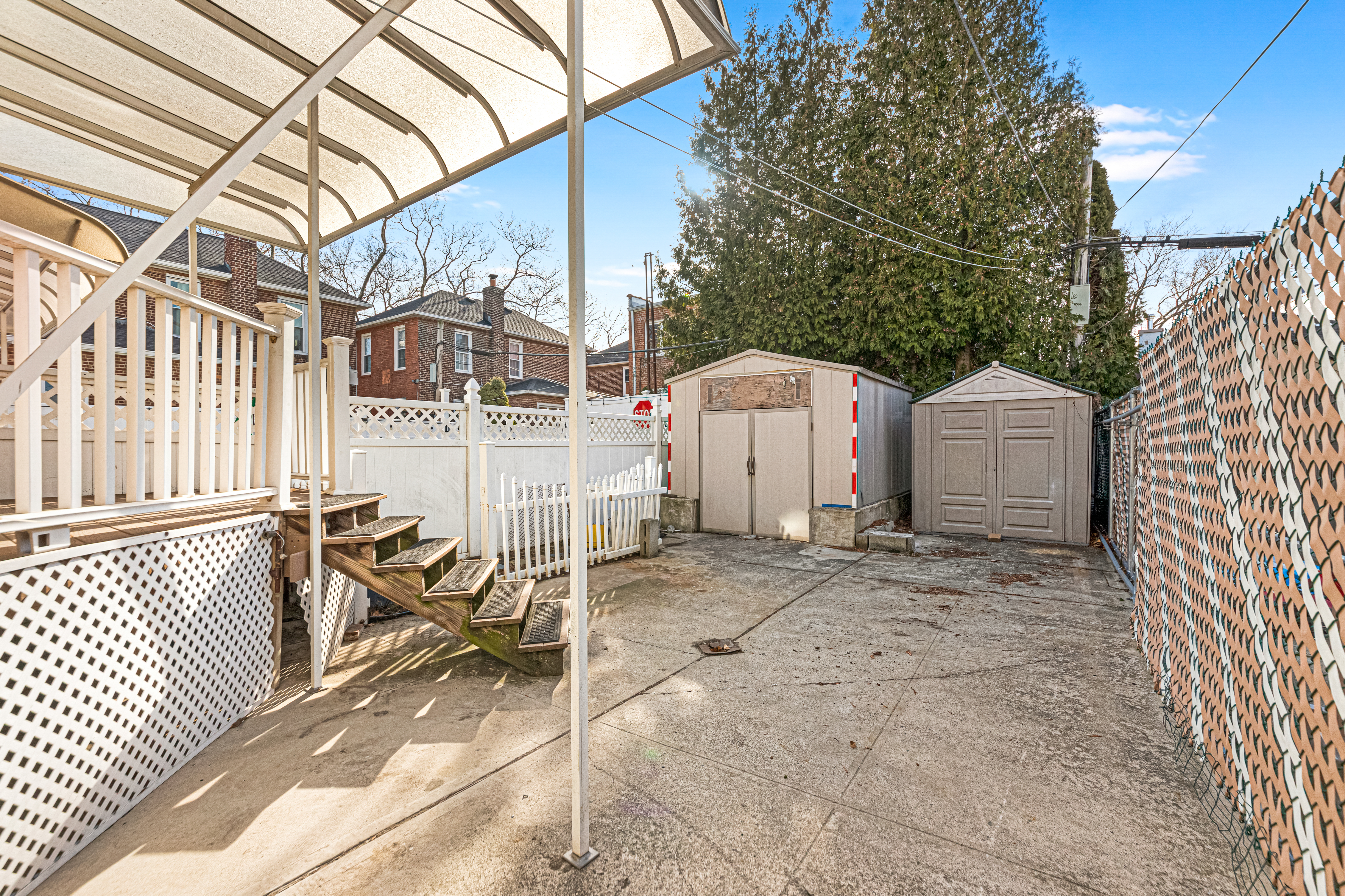 1874 Ryder Street Brooklyn, NY 11234 - Photo 19 of 20 a view of a patio with table and chairs with wooden fence and plants