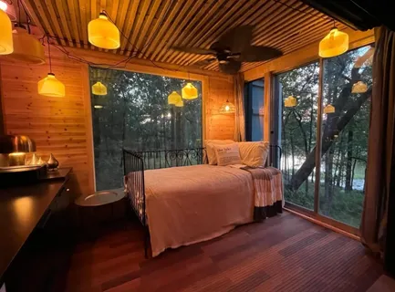 a bed room with a bed and a lamp