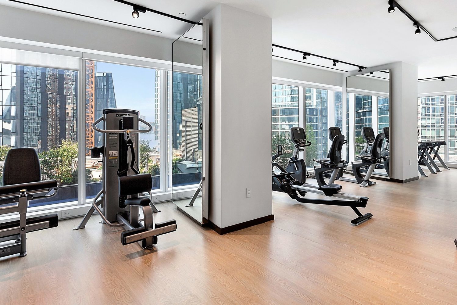 1 West End Avenue, Unit 15E Manhattan, NY 10023 - Photo 25 of 31 a view of a livingroom with gym equipment and floor to ceiling window