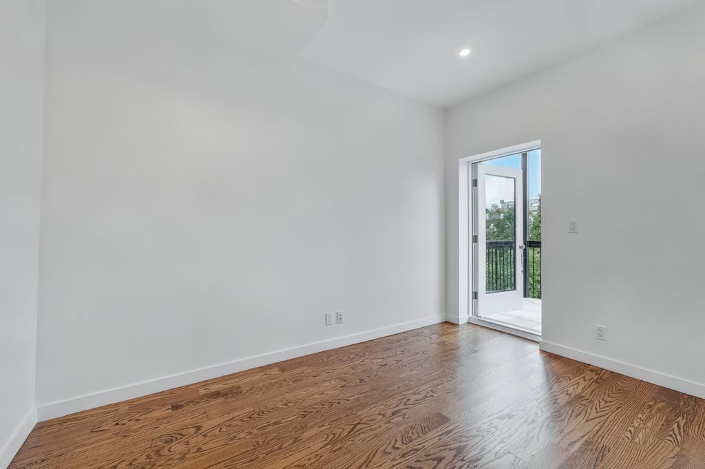 109 President Street, Unit 3 Brooklyn, NY 11231 - Photo 12 of 18 an empty room with wooden floor and windows