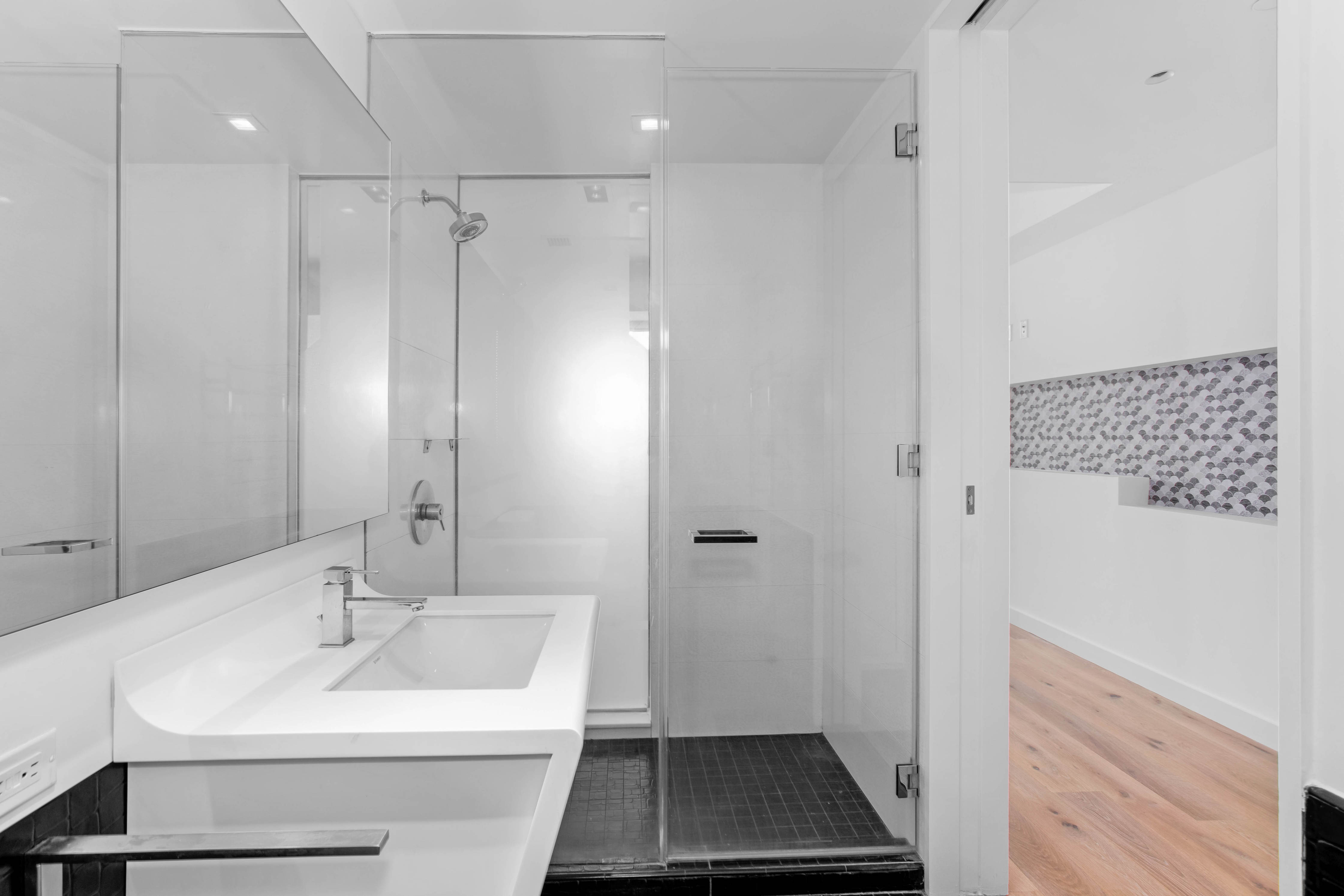 123 Washington Street, Unit 30F Manhattan, NY 10006 - Photo 5 of 8 a bathroom with a sink a toilet a shower and a mirror