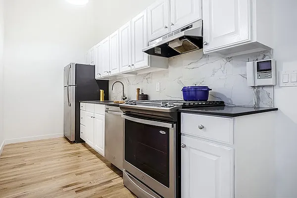204 Huntington Street, Unit 3I Brooklyn, NY 11231 - Photo 2 of 5 a kitchen with stainless steel appliances granite countertop a stove and a refrigerator