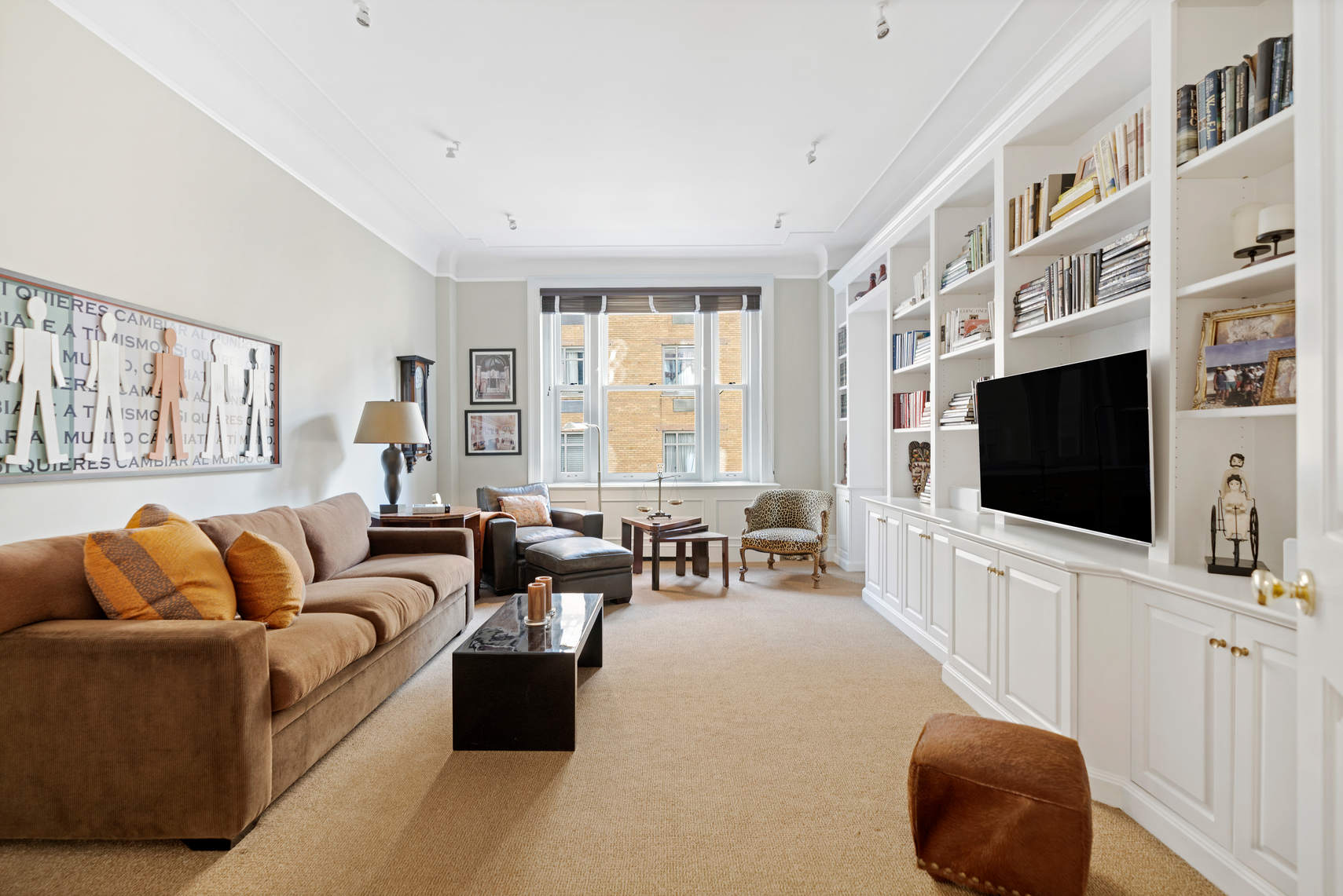 850 Park Avenue, Unit 7D Manhattan, NY 10075 - Photo 11 of 20 a living room with furniture and a flat screen tv