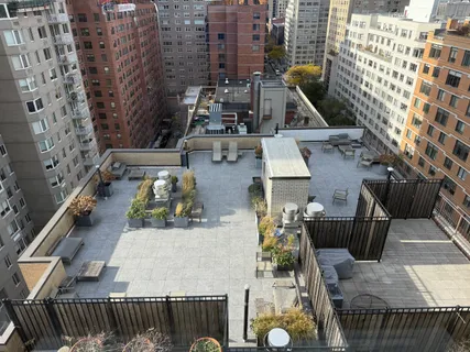 an aerial view of a balcony with chairs and wooden floor
