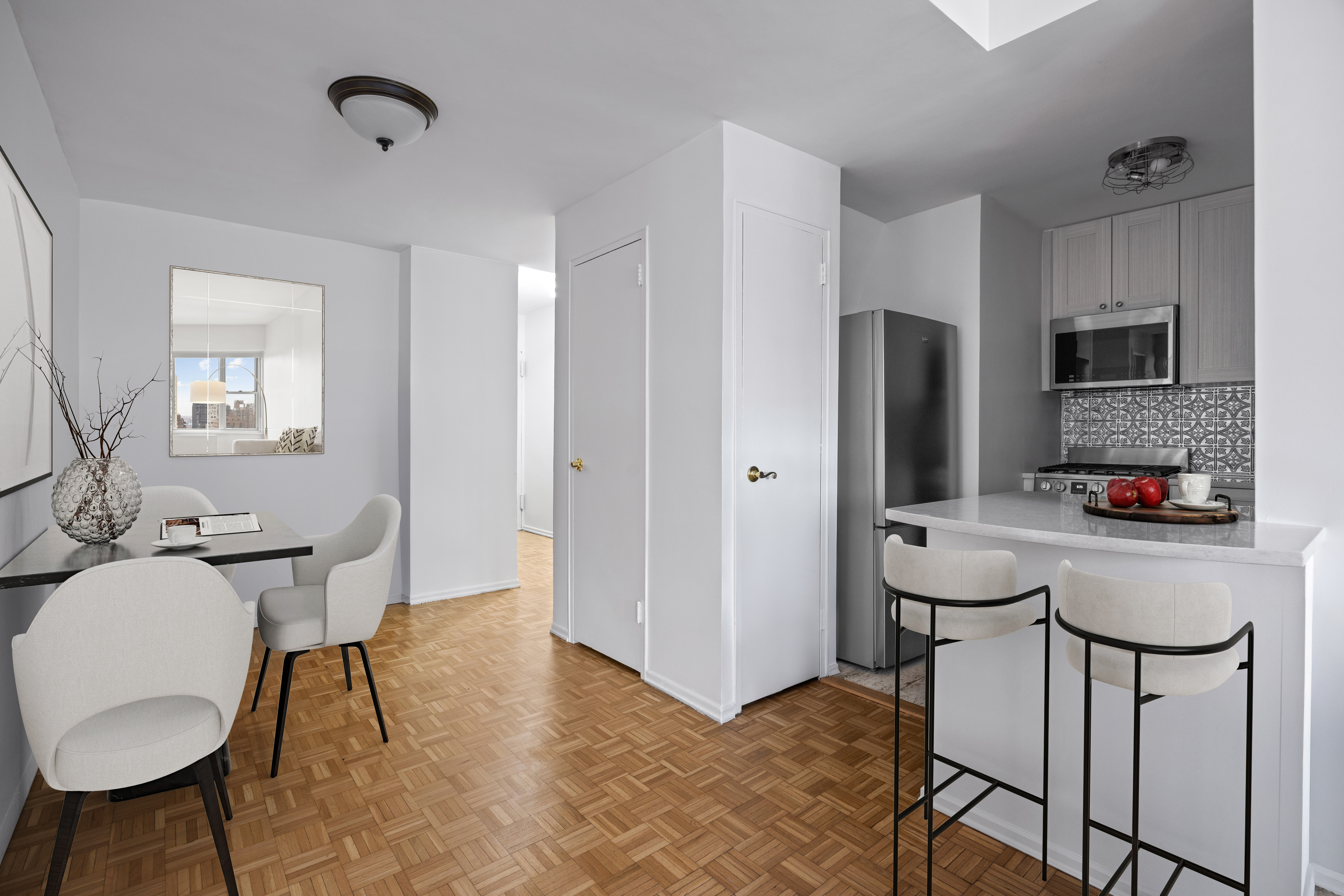 400 East 85th Street, Unit 14A Manhattan, NY 10028 - Photo 4 of 8 a bathroom with a sink a light fixture a toilet and a mirror