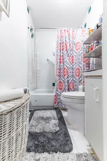 a bathroom with a toilet and a shower
